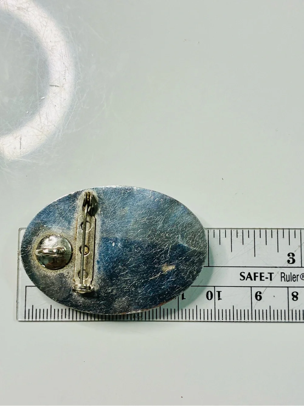 Elevated Simple Black and Silver Oval Brooch with Mother-of-Pearl Center Pendant